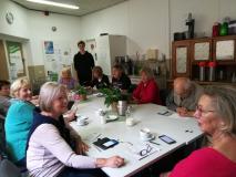 Lernsituation einer Seniorengruppe an einem Tisch mit Smartphones
